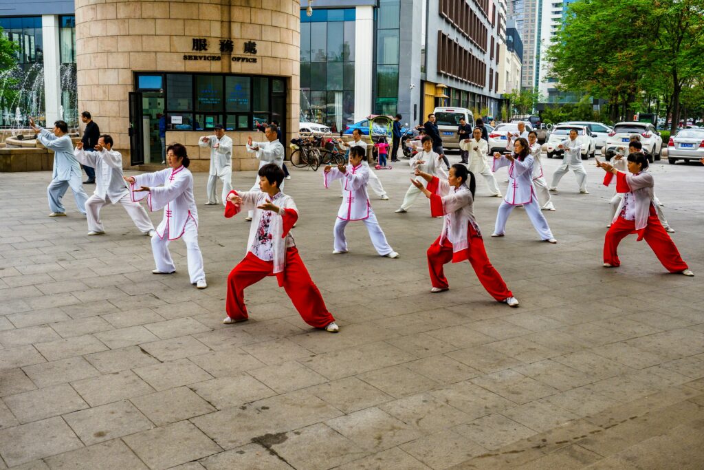 A group of people doing tai chi exercise - How to live a stress free life - pohernsi.com Buddhist temple Penang